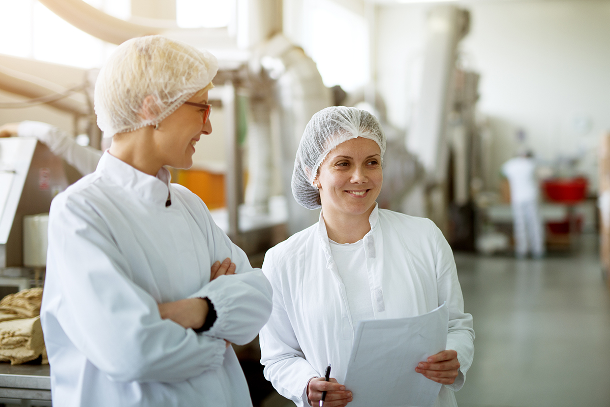 Two workers are having a chat in factory